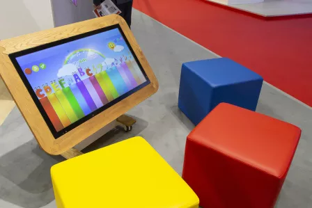 BIG PAD interactive display with three coloured stools around it